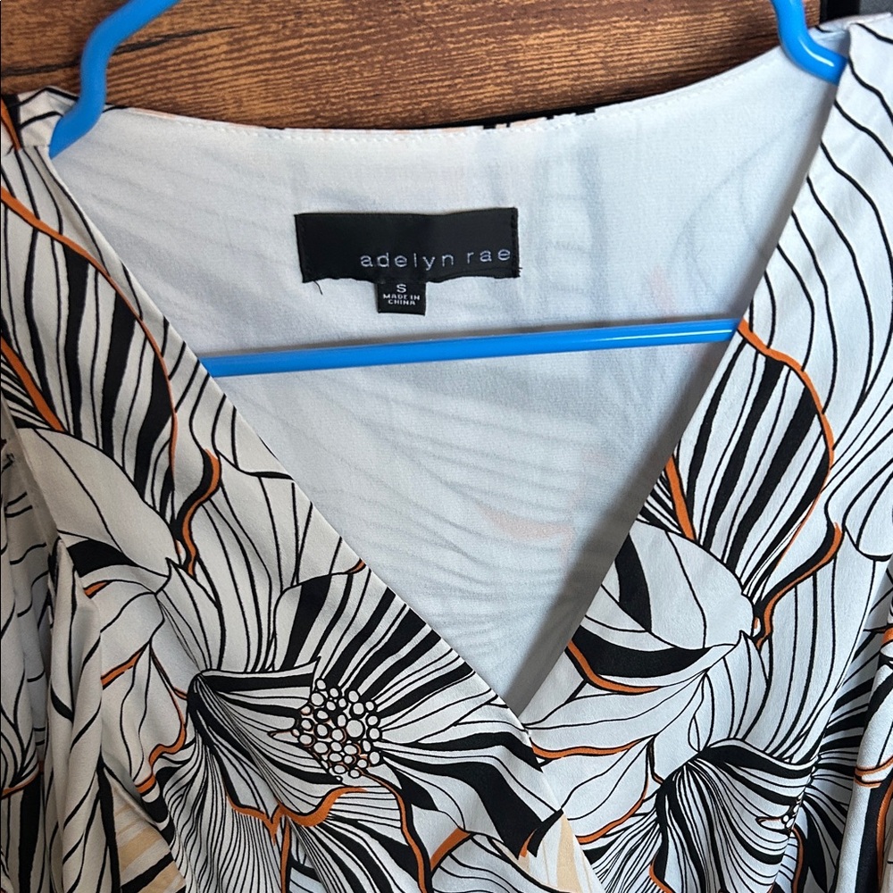 Adelyn Rae Black and Orange Patterned Romper - Picture 4 of 9